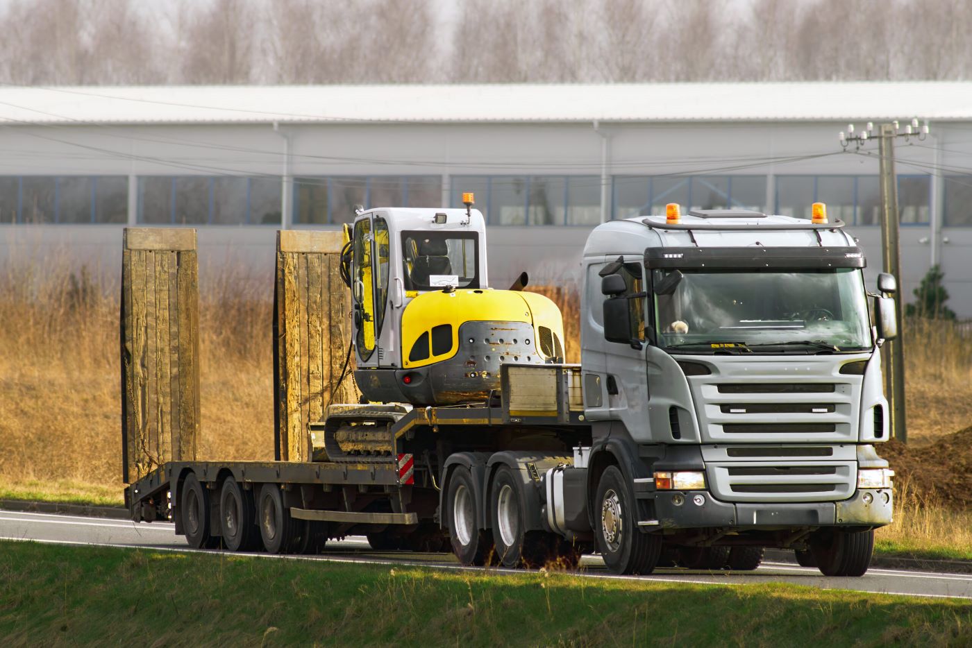 industrial-excavator-flatbed-truck-ready-earthworks-scaled